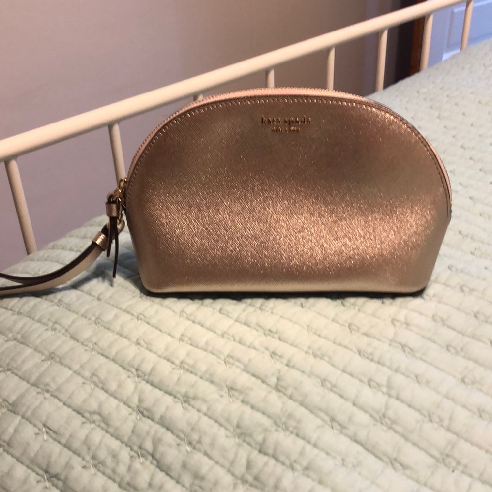 Kate Spade gold pouch/wristlet in excellent condition.
